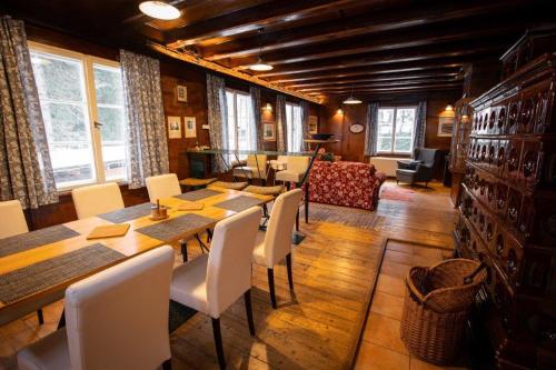 a dining room with a long table and chairs at Rakouská vila in Bělá pod Pradědem