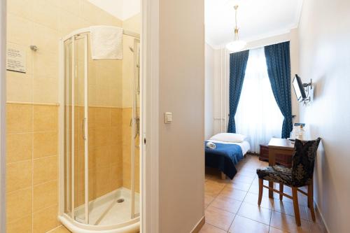 a bathroom with a shower and a bedroom at Budapest Panorama Central in Budapest
