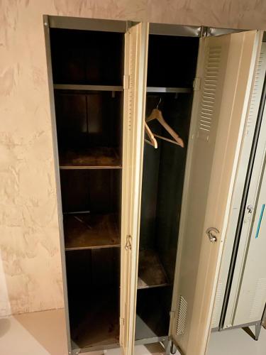 a wardrobe with glass doors in a room at König Albert Industrie Loft in Bitterfeld
