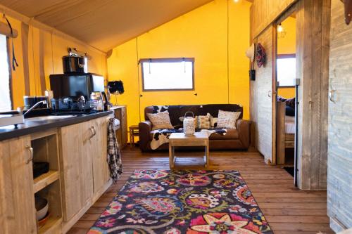 a living room with a couch and a table at Finest Retreats - Rusty Lane, Safari Lodge in Seend