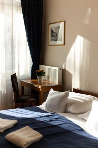 a bedroom with a bed and a desk and a table at Budapest Panorama Central in Budapest