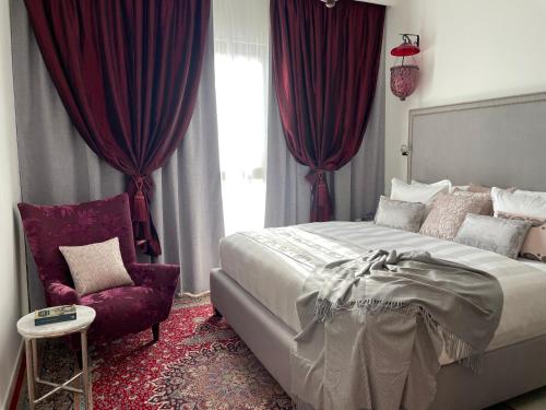 a bedroom with a large bed and a chair at Madinat Jumeirah Living in Dubai