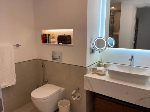 a bathroom with a toilet and a sink and a mirror at Madinat Jumeirah Living in Dubai