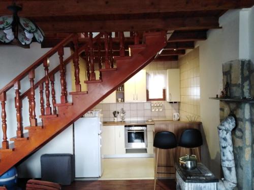 a kitchen with a staircase in a house at Apartments Holiday Home Srce in Kopaonik