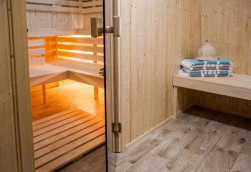 a room with a sauna with a door open at Kaszubskie Zacisze in Władysławowo
