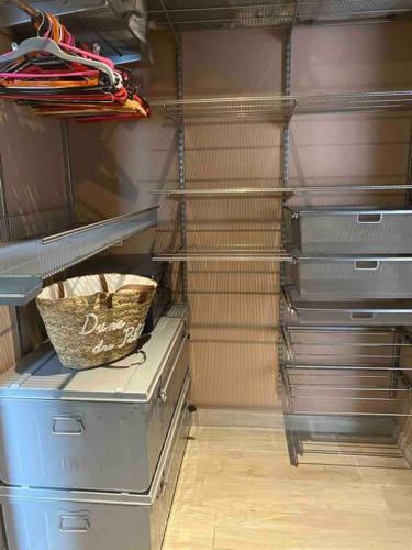 a closet with drawers and a basket on the shelf at Frenchy home☆ piscine ☆spa☆ bassin d’arcachon in Mios