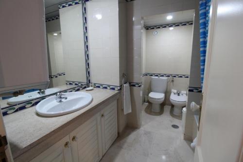a bathroom with a sink and a toilet at Marina Mar Light by SAPvillas in Vilamoura
