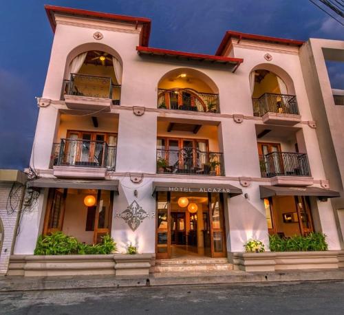 a large white building with balconies on it at Hotel Alcazar in San Juan del Sur