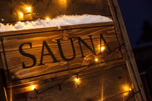 a sign with snow and lights on it at Kaszubskie Zacisze in Władysławowo