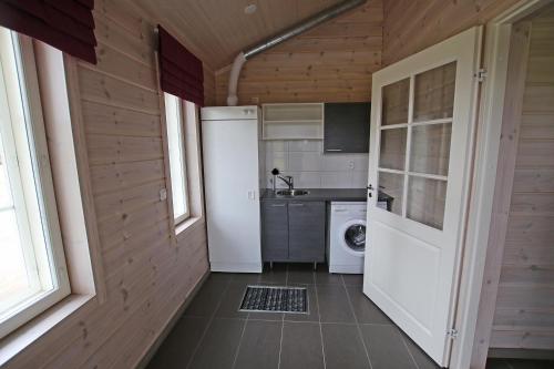 a small kitchen with a washer and dryer at Tallusniemi Villas in Oravi