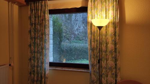 a window with a view of a yard at Alp House in Bohinjska Bela