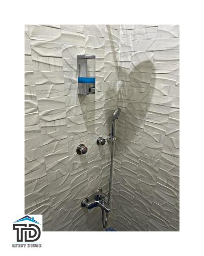 a bathroom with a shower with a plastic wall at TD Guest House 5 Lite in Chimoio
