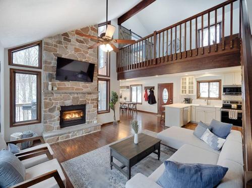 a living room with a couch and a fireplace at Highland House: Lakefront, Hot Tub, Views, Private in East Stroudsburg