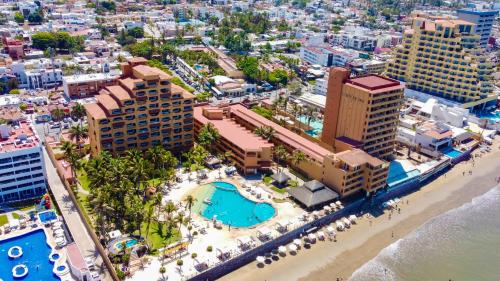 an aerial view of a resort with a beach and buildings at Costa de Oro Beach Hotel in Mazatlán