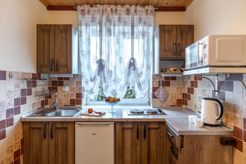 a kitchen with a sink and a window at Emerald House in Mykulychyn
