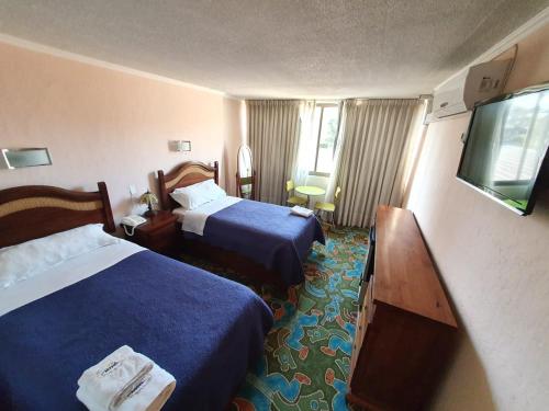 En eller flere senger på et rom på Hotel San Felipe el Real