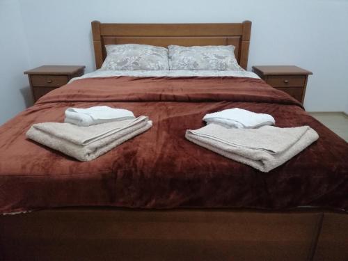 a bed with two towels on top of it at Apartment Sailor in Žabljak