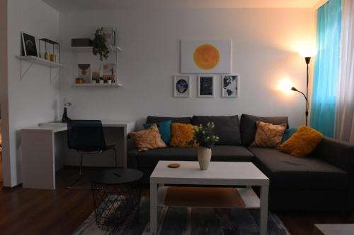 a living room with a couch and a table at Central Apartment in Ćuprija