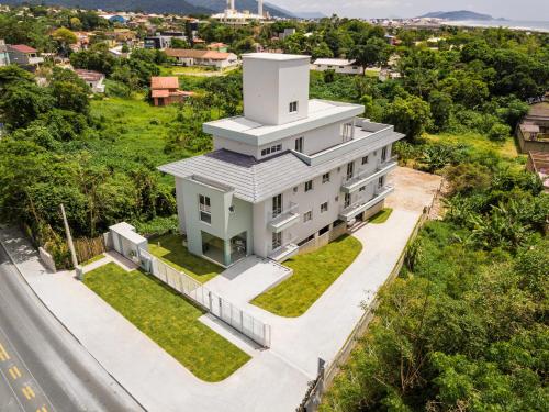 an aerial view of a white building with a tower at Parador Campeche in Florianópolis
