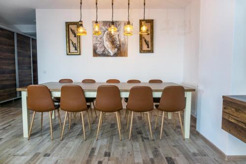 a dining room with a table and chairs at KOA - Sunset Penthouse in Braşov