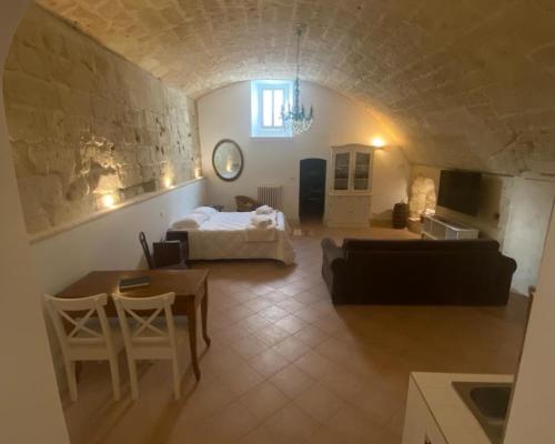 a large living room with a bed and a couch at Le Case Nuove Room in Matera