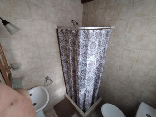 a shower curtain in a bathroom with a toilet at Los tilos in San Antonio de Areco