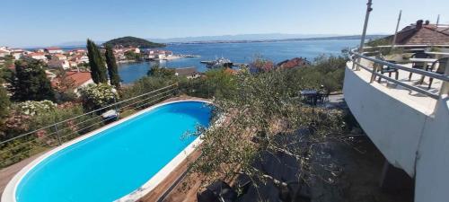 a swimming pool with a view of the water at Apartments Novis - close to the sea in Kali