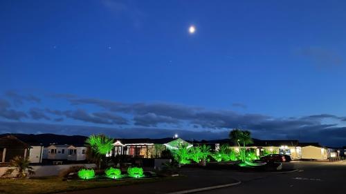 a city street at night with green lights at Cozy Private Static Caravan at Llyons Robin Hood - Silver Birch Way 11 in Rhyl