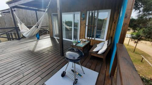 a porch with a hammock and a grill on it at Marasaias in La Pedrera