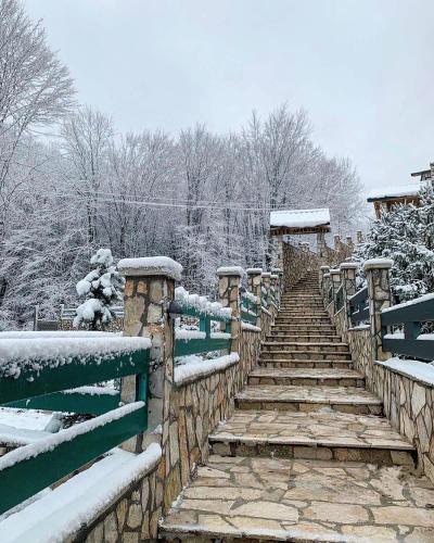 a wooden stairway with snow on top of it at Elite Apartments in Kolašin