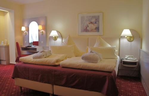 Giường trong phòng chung tại Sletz Parkhotel - Superior