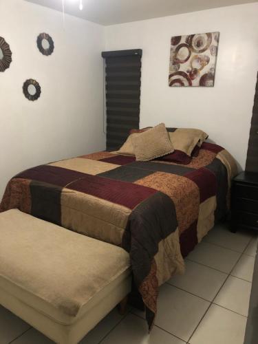 a bedroom with a large bed and two clocks on the wall at Condo Vacational in Ensenada, B.C. in Ensenada