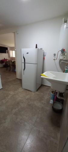 a kitchen with a white refrigerator and a sink at Nuestro Sueño in San Rafael