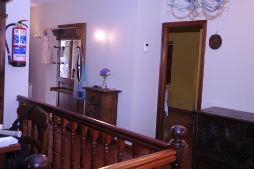 a stairway with a wooden railing and a stair case at Bekoabadene in Menaka