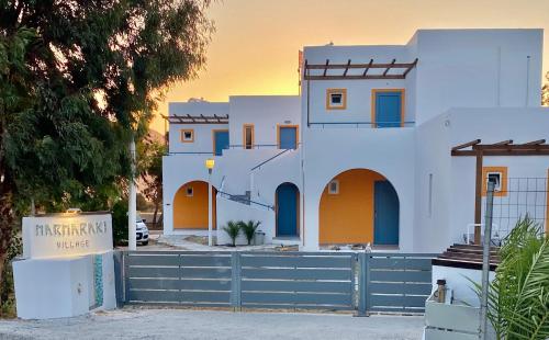 a house with a fence in front of it at Marmaraki Village House & Apartments in Kardamaina