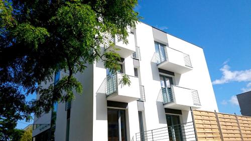 a white building with balconies on it at Willa Długa No. 4 Bed & Breakfast in Gdynia