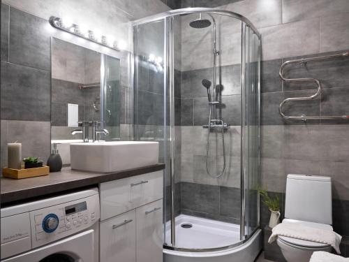 a bathroom with a shower and a sink and a toilet at Студия 15 in Irkutsk