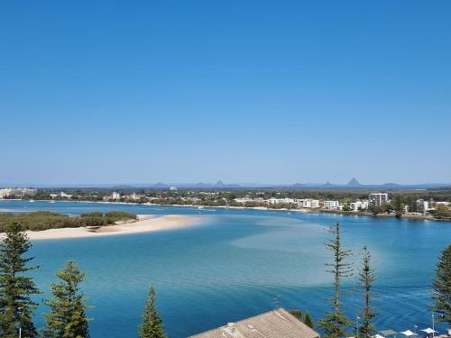 a view of a river with a beach and buildings at The Waterford Prestige Apartments in Caloundra