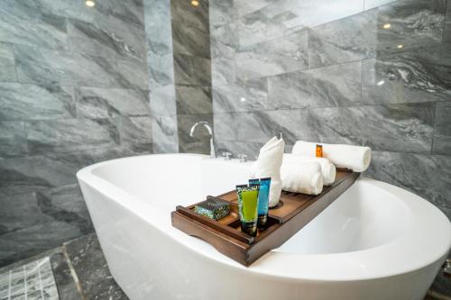 a bathroom with a bath tub with a tray on it at OCEAN HOTEL in Phnom Penh