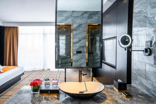 a bathroom with a tub and a sink in a room at OCEAN HOTEL in Phnom Penh