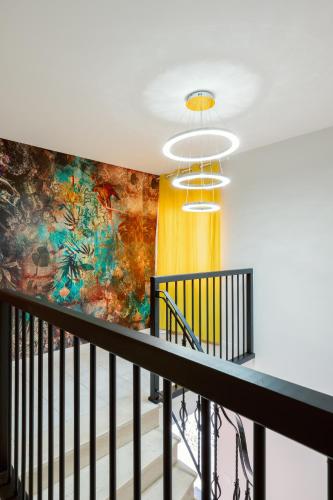 a mural on the wall of a hallway with a staircase at La Bonbonnière by Leslodgespa in Hésingue