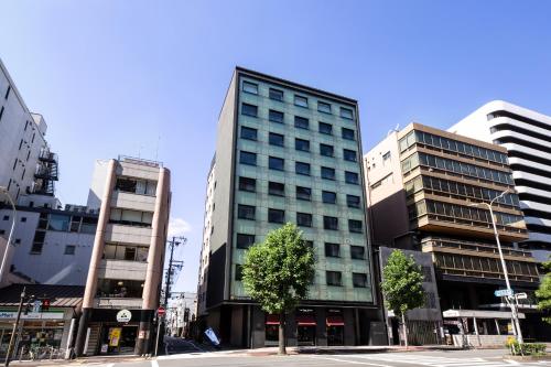 a tall building in the middle of a city at The Royal Park Hotel Kyoto Shijo in Kyoto