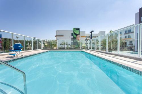 a swimming pool on top of a building at Wyndham Anaheim in Anaheim