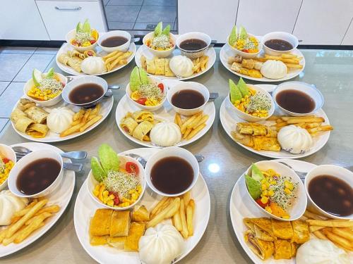 a table with plates of food and bowls of dips at 光腳丫宜蘭民宿 in Dongshan
