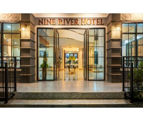 a lobby of a hotel with the entrance to theine river hotel at Nine River Hotel in Ratchaburi