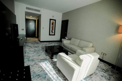 a living room with a couch and a table at Baia Bursa Hotel in Bursa