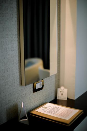 a bathroom with a mirror and a table with a sink at Baia Bursa Hotel in Bursa