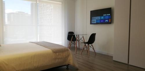 Postelja oz. postelje v sobi nastanitve Acogedor Apartamento en Centro Internacional Bogotá