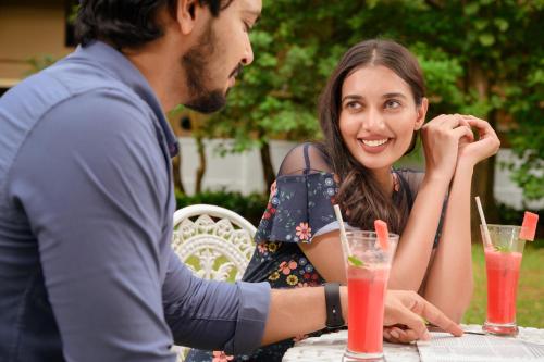 a man and a woman sitting at a table at Surya Heritage Hotels in Kannur