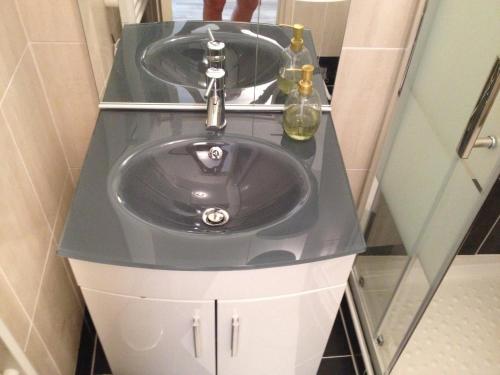 a bathroom sink with a glass counter top at Chez Louis in Les Issambres